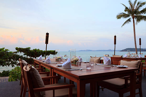 istock Outdoor restaurant tables, dinner setting at the beach 453663973