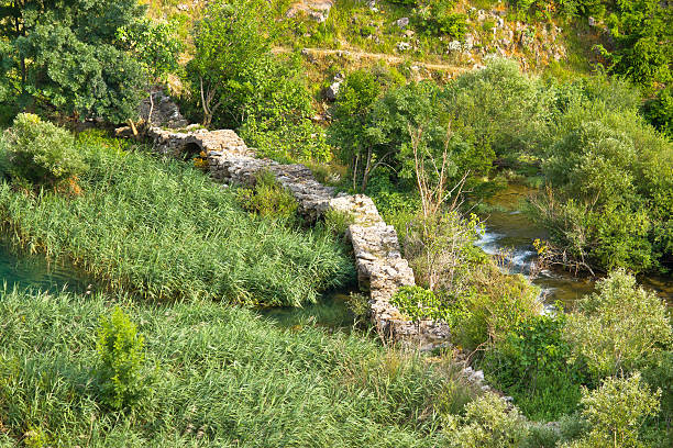 A clear moorland stream, Hutton Beck winds its way through the picturesque town of Hutton-Le-Hole village in North Yorkshire in rural England.