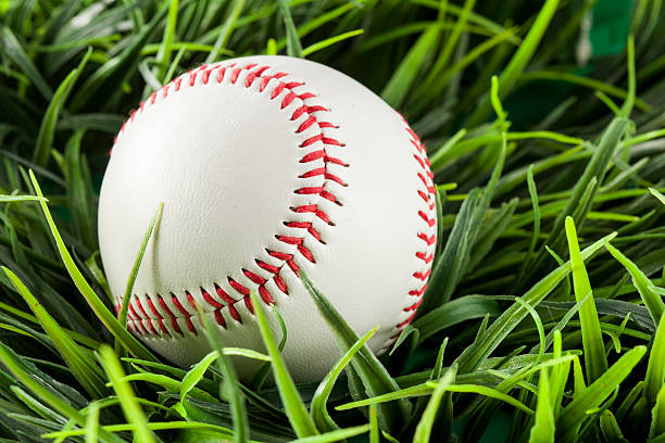 istock New White Baseball in green grass 453667429