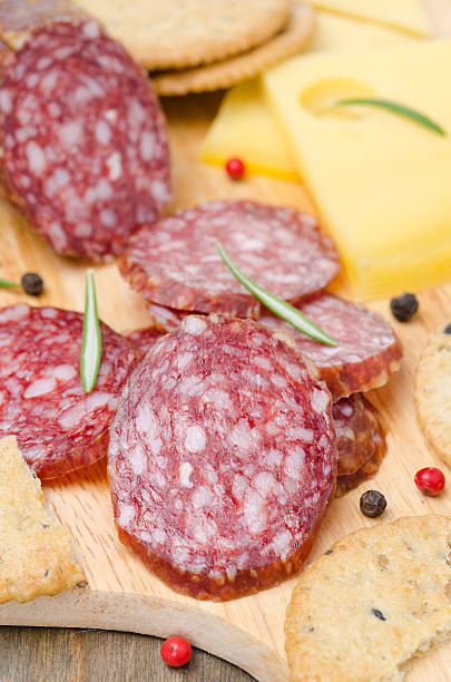 istock salami, cheese and crackers on a cutting board, closeup 453669915