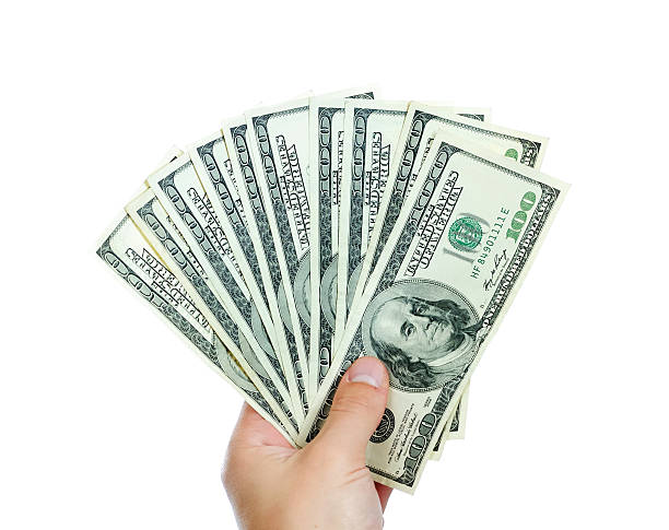 istock Female hands with dollars isolated on a white background 453681327