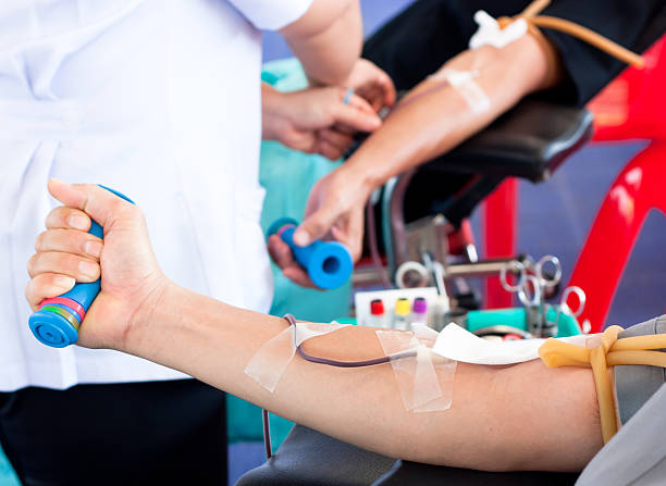 arm of a donor donating blood at hemotransfusion station stock photo