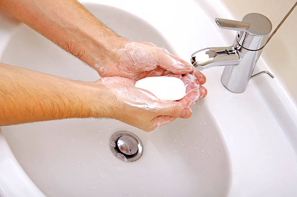 istock Close-up of human hands being washed under stream 453684975