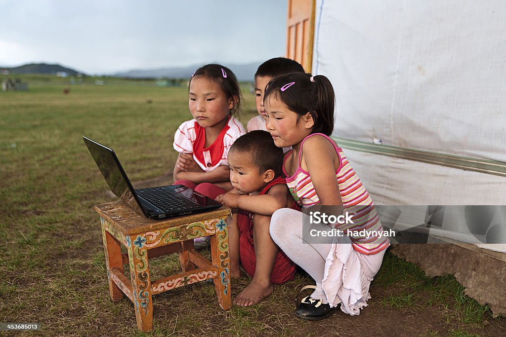 Mongolian children using laptop Mongolian children using laptop, ger in the background Green Color Stock Photo