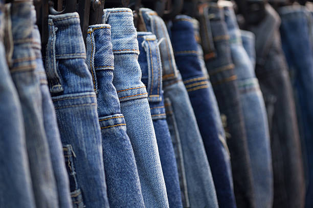istock Row of hanged blue jeans in a shop 453692579