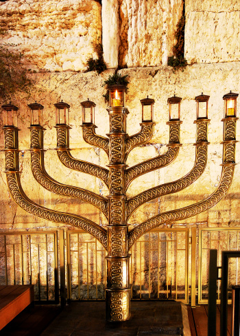 A Menorah is a candle stand with nine branches. Usually eight candles - one for each day of the Festival Hanukka - are of the same height, with a taller one in the middle, the shamash (\