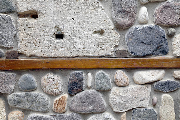 istock Wall of rocks and stones in cement. 453697663