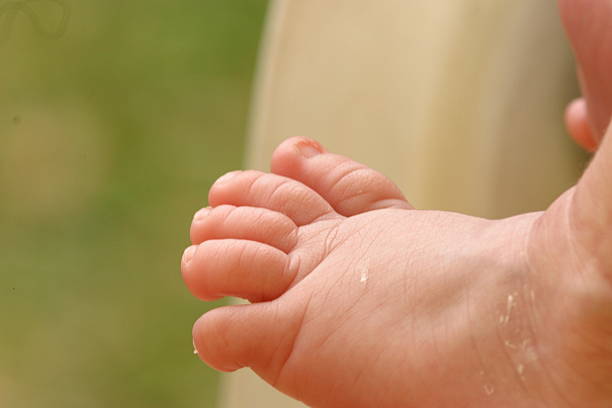 istock Newborn baby feet and toes 453724353