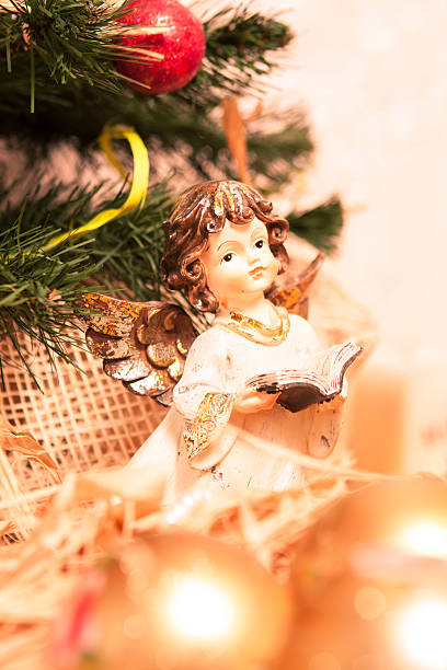 istock christmas angel with book in gold 453724969