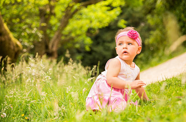 istock Baby girl crawling through grass 453729043