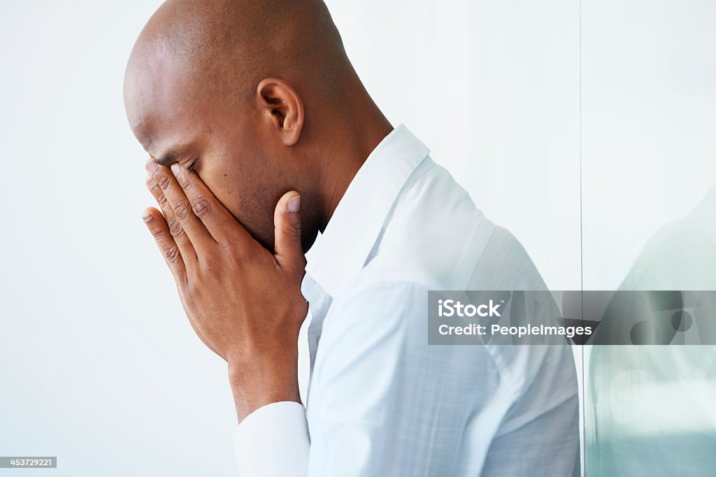 Risks sometimes don't pay off... A young businessman crying with his face in his hands Men Stock Photo