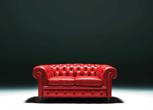 Red Leather Chester sofa in empty room with intense shadows a chestr sofa studio isolated chester england stock pictures, royalty-free photos & images