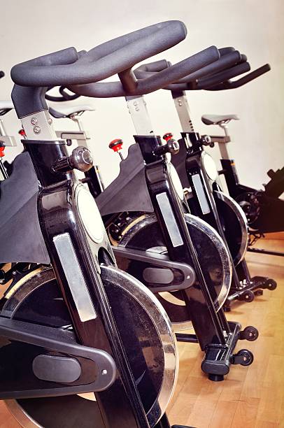 istock Group of exercising bicycles at fitness studio 453736069