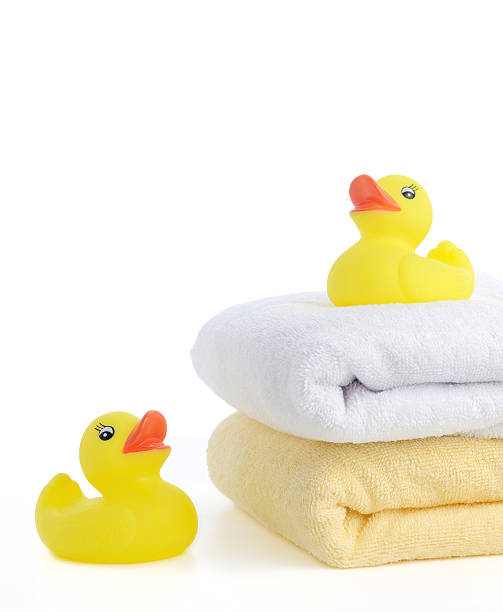 istock Bath accessories: towels and Yellow rubber duckies 453757423