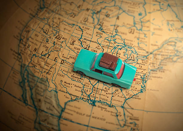 Toy car with luggage on a vintage globe map of the United States with a shallow depth of field.