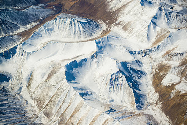 aerial view of mountains and clouds on top