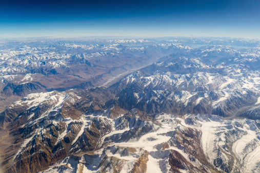 aerial view of mountains and clouds on top