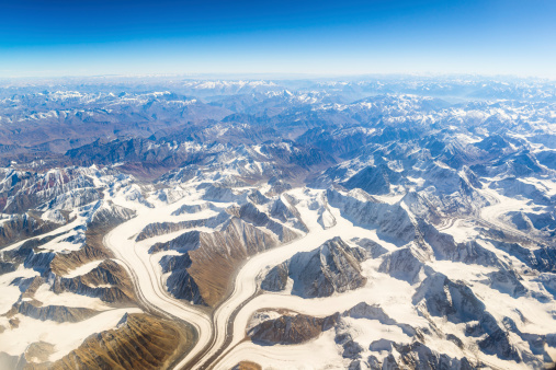 aerial view of mountains and clouds on top