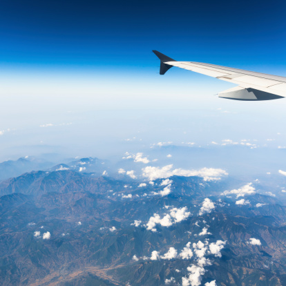 aerial view of mountains and clouds on top