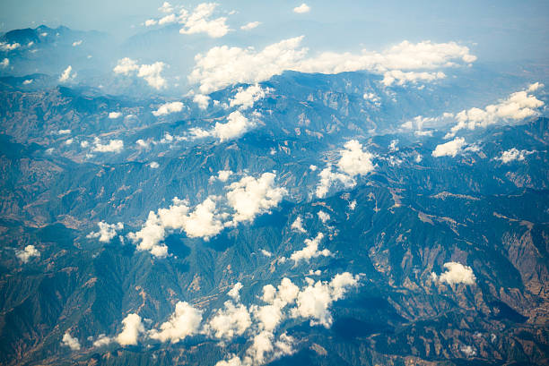 aerial view of mountains and clouds on top