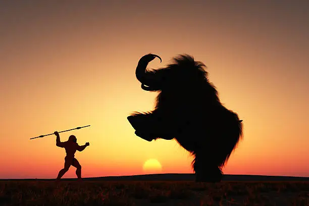 A neanderthal man hunting a mammoth.