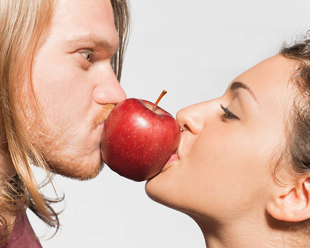 istock Boy and girl kiss an apple 453765553