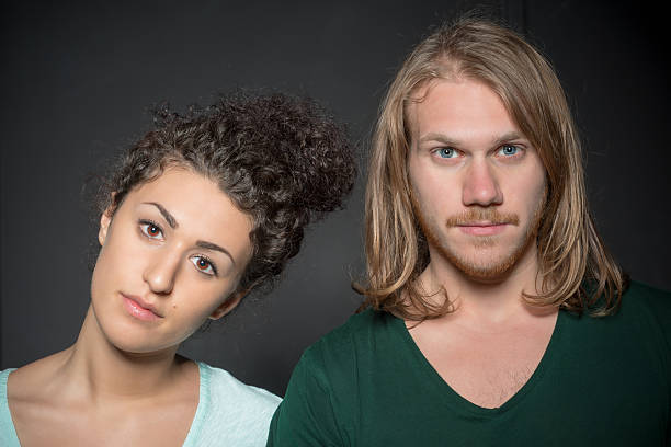 istock Boy and girl standing on black background 453765591
