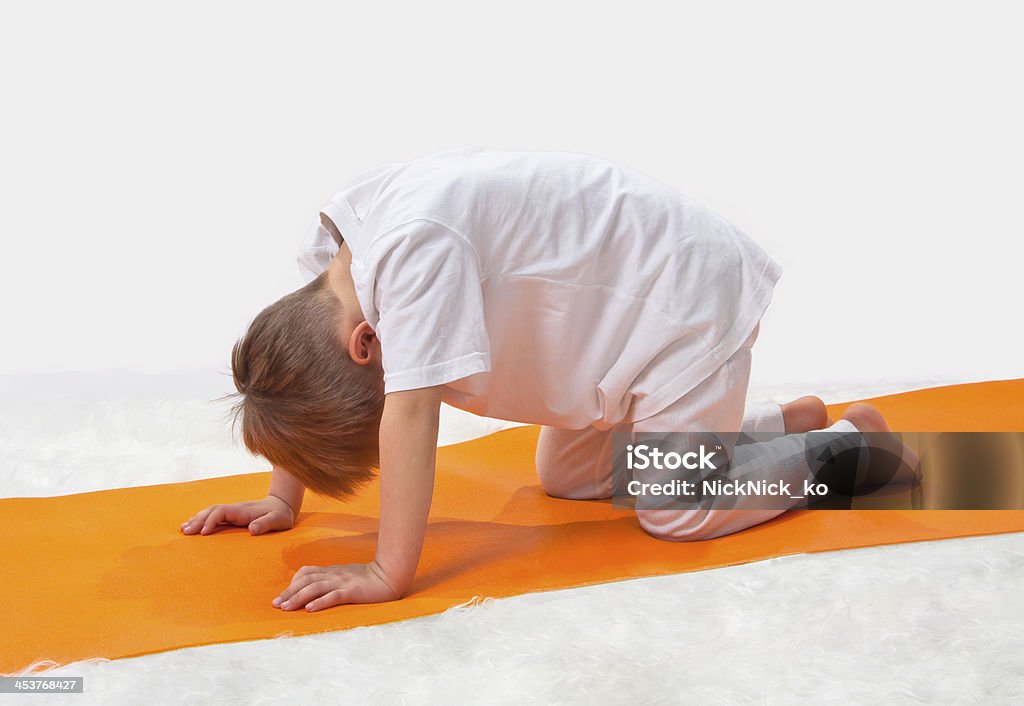 Children's yoga. The little boy does exercise. Activity Stock Photo