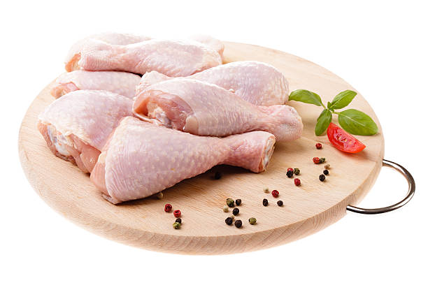 istock raw chicken legs on wood 453770113