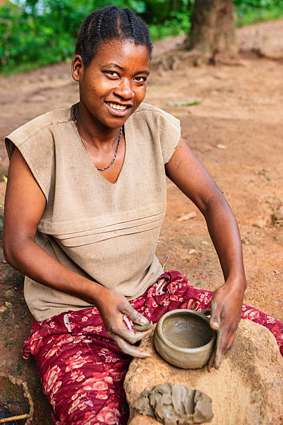 istock Young Ethiopian woman making pottery 453770907