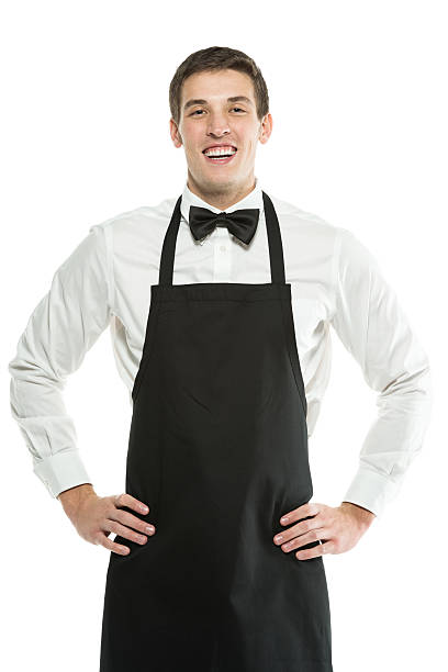 istock Smiling young waiter standing with hands on hips 453771331