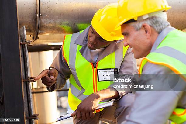 Mechanical Engineers Working On Fuel Pipeline Stock Photo - Download Image Now - Active Seniors, Adult, African Ethnicity