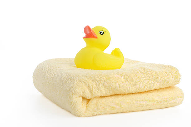 istock Bath accessories: towels and Yellow rubber duckies 453772943