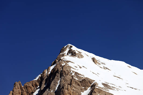 istock Mountain top with snow and cloudless blue sky 453774717