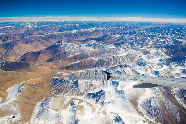 aerial view of mountains and clouds on top
