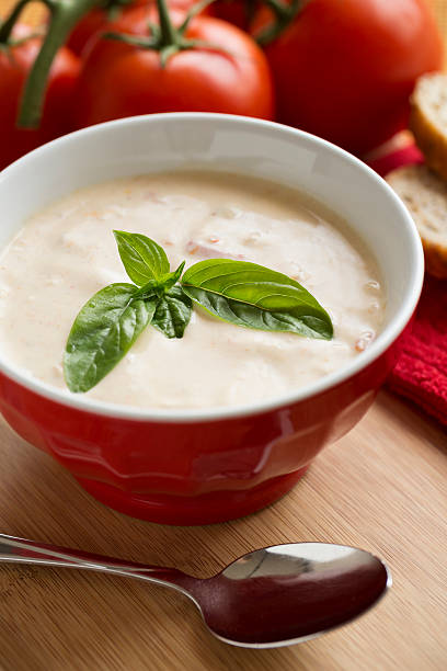 istock Bowl full of creamy bisque soup with basil garnish 453787013