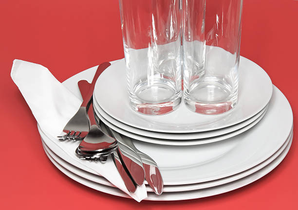istock Pile of white plates, glasses, forks, spoons. 453790441