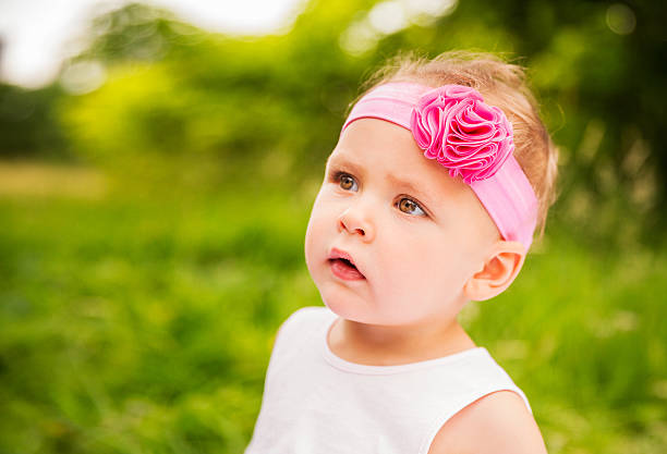 istock Interested little baby girl looking at copy space 453795521