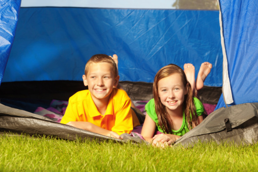 Subject: Children in a tent in outdoor camping vacation trip.