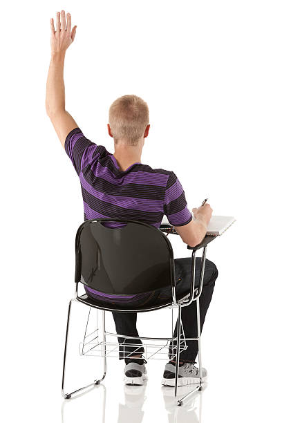 Young student raising his hand to answer the questionMore from this model;