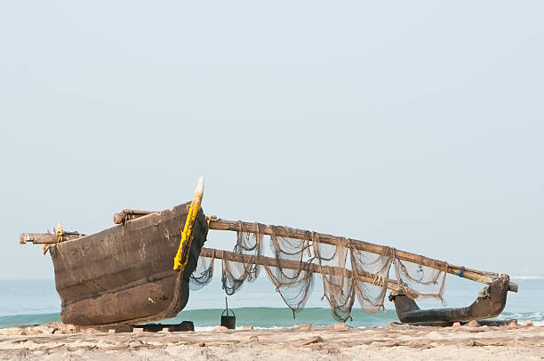 istock Indian fishing boat on white sandy beach beside ocean 453807193