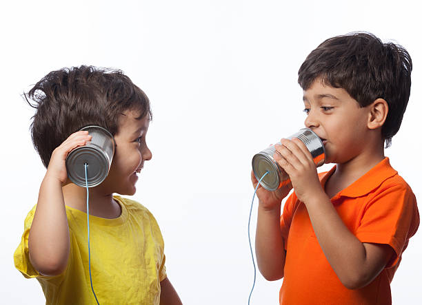Little Boys Communicating Via Can Phone,Studio Shot