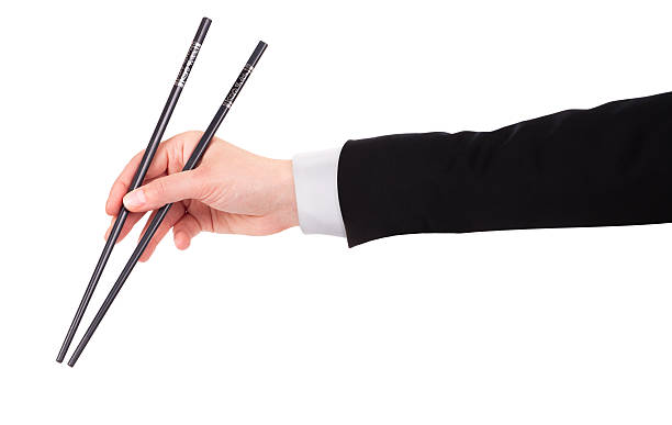 istock Businessman's hand Holding Chopsticks 453810923