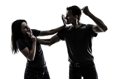 Husband beating up wife. Concept of domestic violence