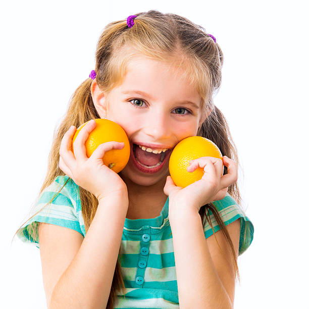 istock little girl with oranges 453815069