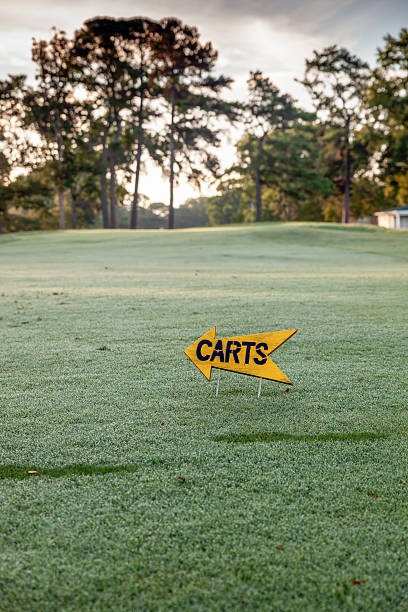 istock Early Morning Dew on Golf Course and Carts Direction Sign 453824847