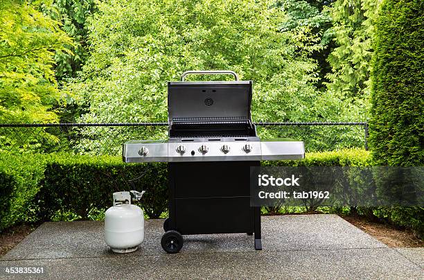 Gas Grill With White Tank On Outdoor Patio Stock Photo - Download Image Now - Barbecue Grill, Natural Gas, Propane