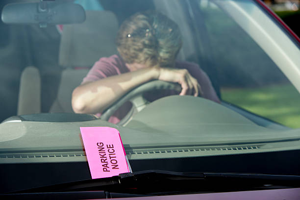 istock Parking Ticket with Woman Head Down on Steering Wheel Car 453839841