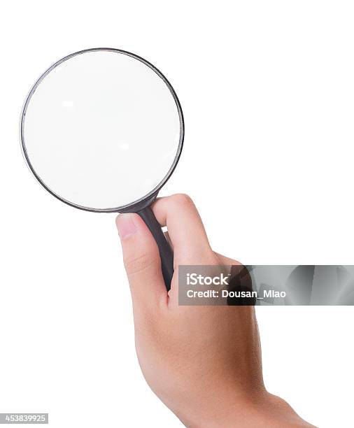 Holding A Magnifying Glass Isolated On White Background Stock Photo - Download Image Now