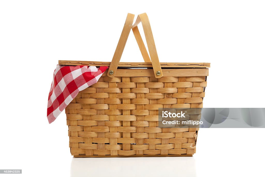 Wicker Picnic Basket with Gingham Cloth A brown wicker picnic basket on a white background with gingham cloth Picnic Basket Stock Photo